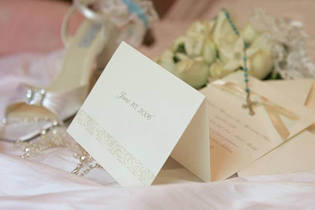 "Wedding invitation with following items in the background: bride's bouquet, cross, garter, jewelery and shoe.You need more wedding and dinner related imagesPlease, follow the link below:"